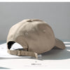 A beige classic cotton dad hat shown in a display setting with the adjustable strap visible.