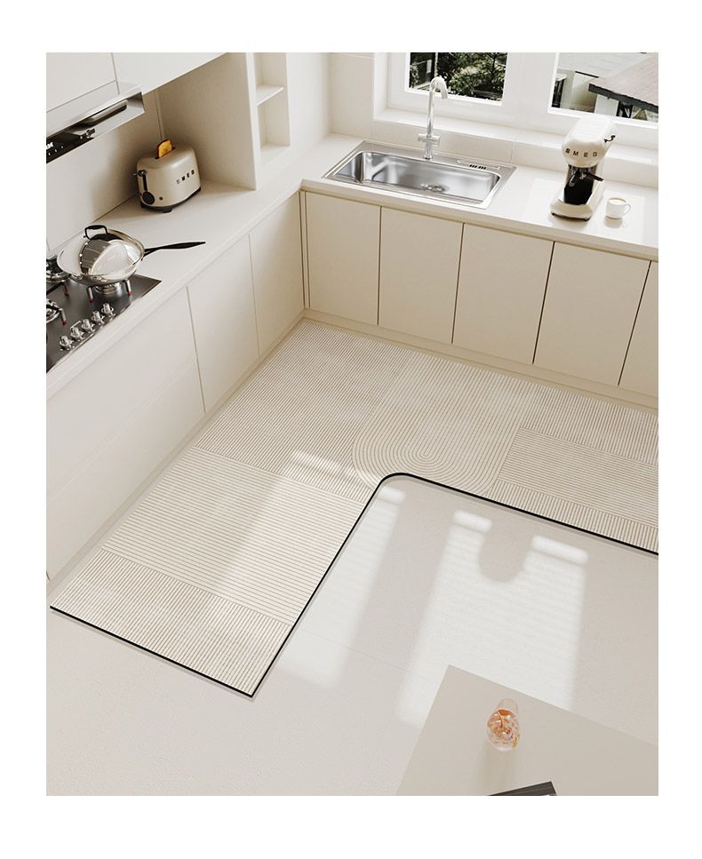 A beige L-shaped kitchen mat with a textured surface and non-slip backing is placed on a light-colored countertop.