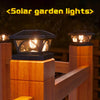 A wooden post cap light with a warm LED illuminates a garden fence or deck area at night.