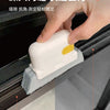 A hand is using a white multi-surface gap cleaning brush with a yellow scouring pad to clean a window track.