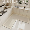 A long, rectangular kitchen mat with a ribbed texture is placed on a light-colored countertop in a modern kitchen setting.