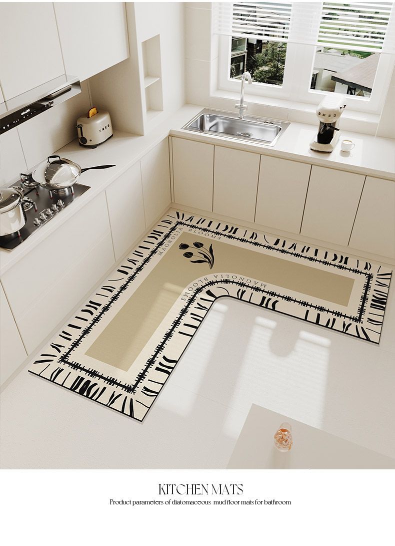 An L-shaped crystal velvet kitchen mat with a black and white patterned border is displayed on a modern kitchen floor.
