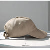 A beige classic cotton dad hat shown in a profile view on a white surface.