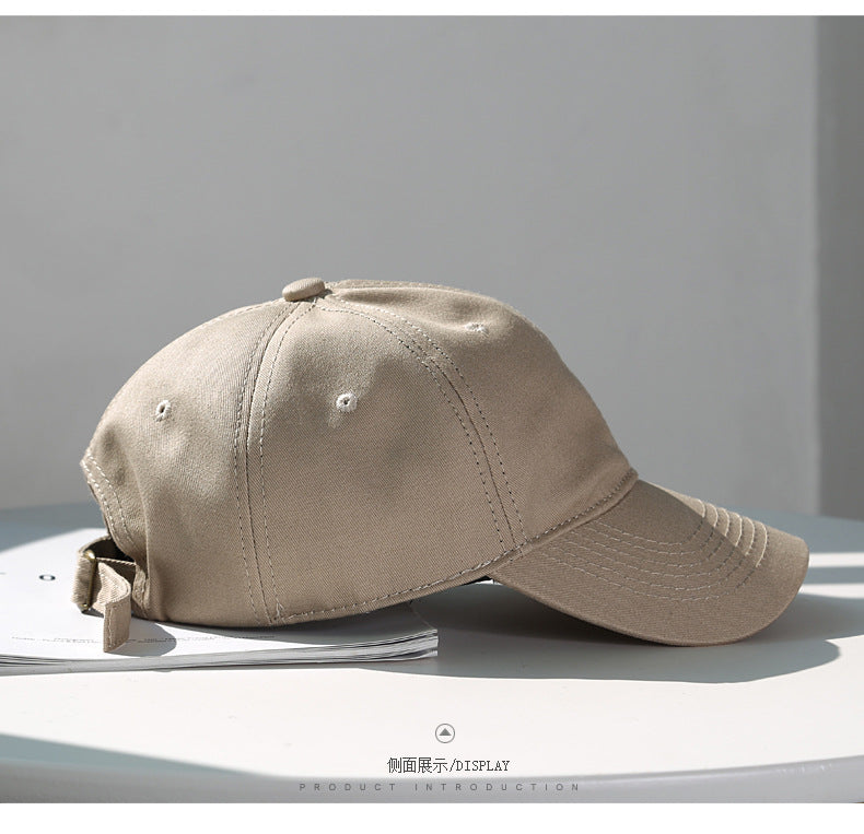 A beige classic cotton dad hat shown in a profile view on a white surface.