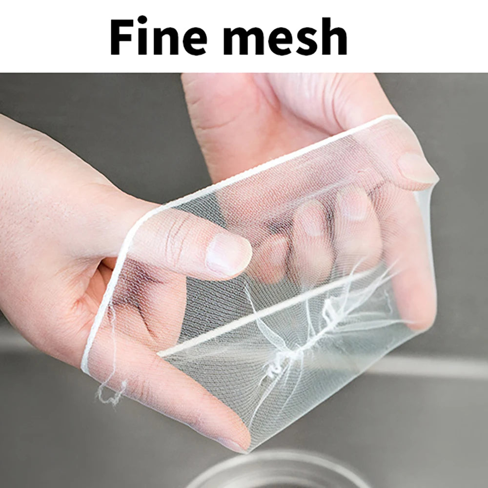 A hand is holding a fine mesh disposable sink strainer bag, demonstrating its delicate texture.