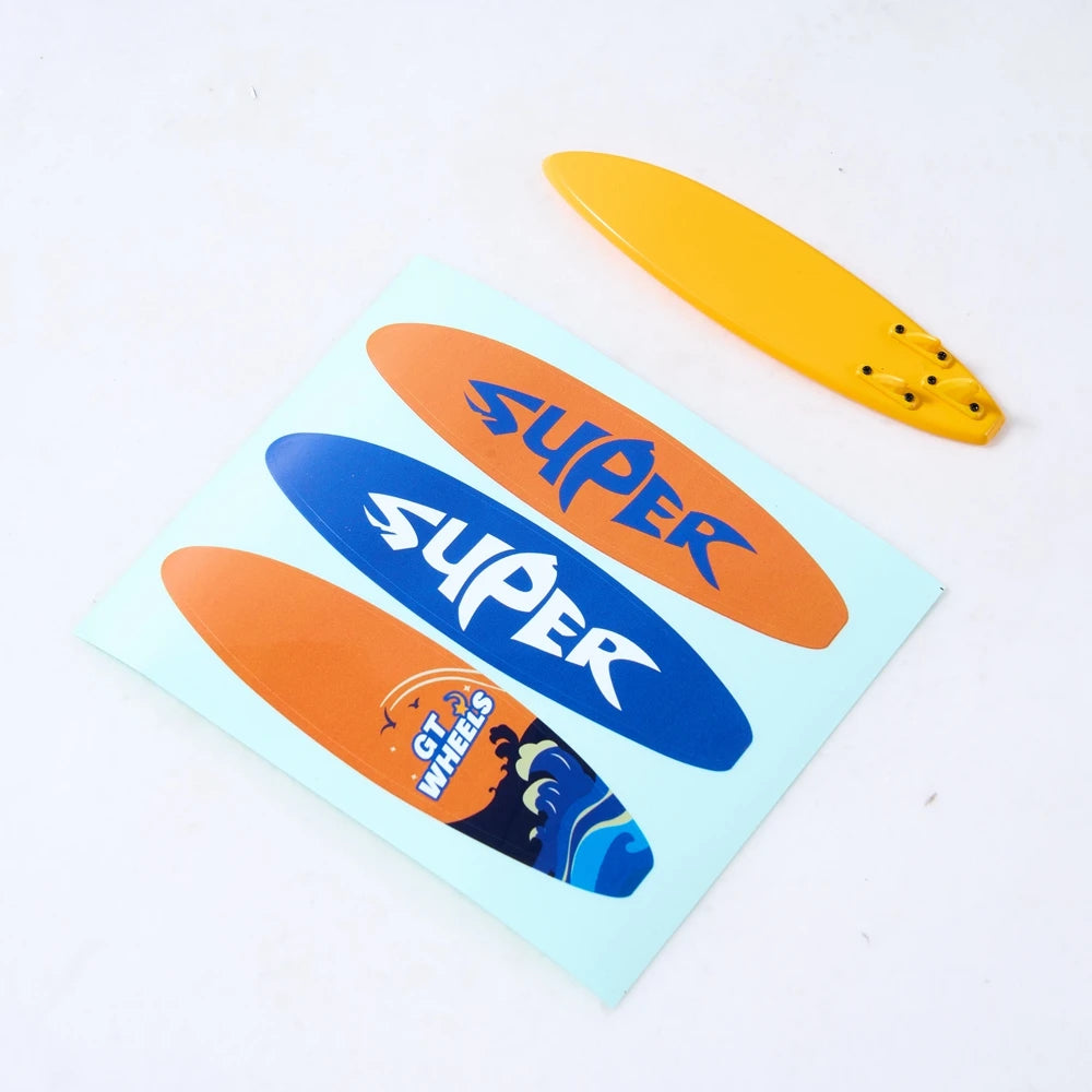 A set of three decorative accessories including a yellow surfboard, a blue kayak, and an orange roadblock on a light blue car