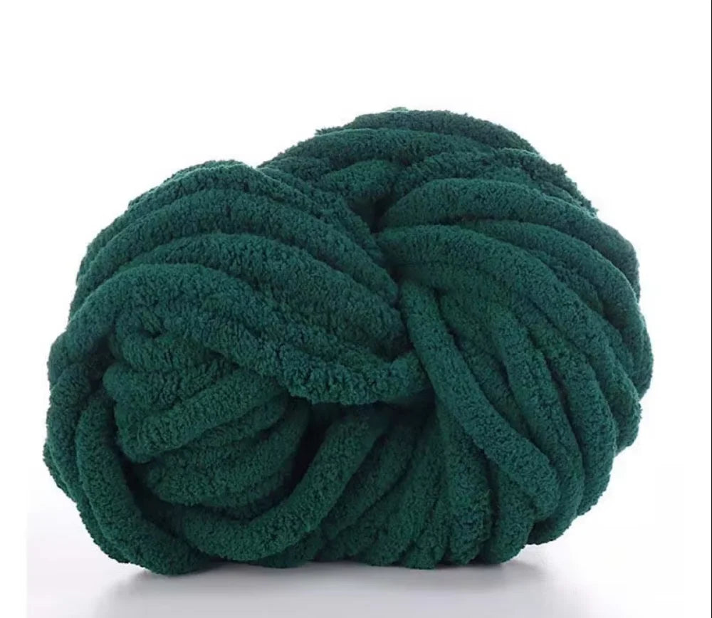 A ball of dark green chunky chenille yarn used for knitting and crochet