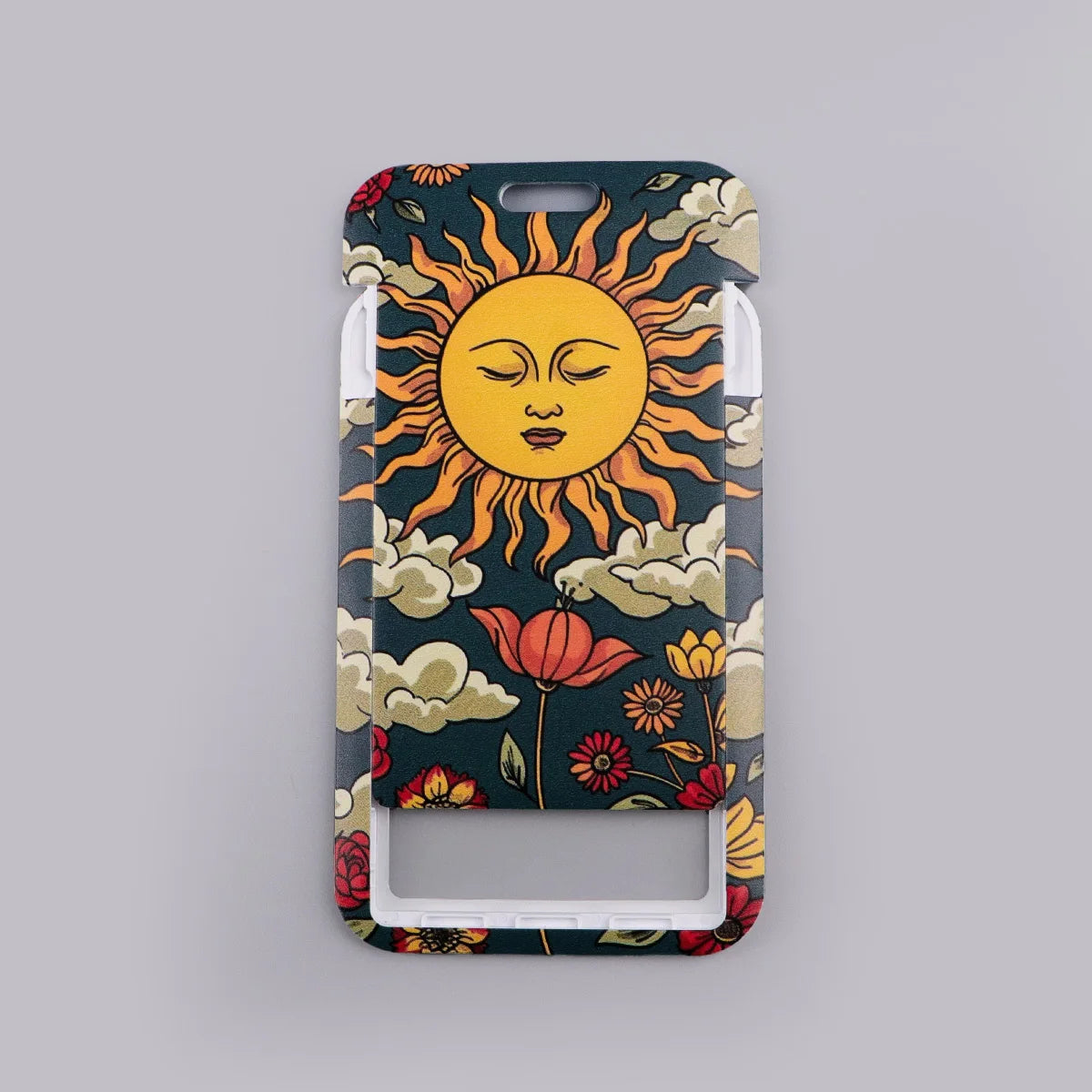 A lanyard featuring a design of a yellow sun with facial features surrounded by orange rays and clouds on a dark background.