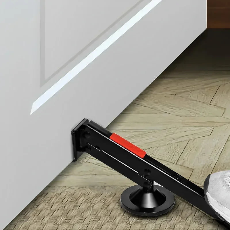 A black door lift tool with an orange handle is shown installed on a white cabinet door.