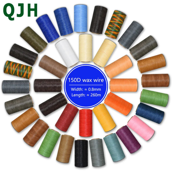 A collection of various colored wax wire threads in spools, including blue, green, brown, and orange tones.