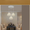 A modern chandelier featuring three crystal glass heads suspended from a ceiling lamp.