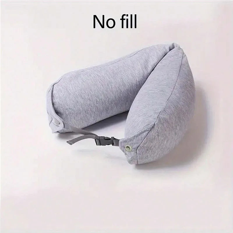 A light gray fillable hooded travel pillow shown with its storage bag, empty.