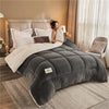 A person is relaxing on a gray weighted fleece blanket in a bedroom setting.