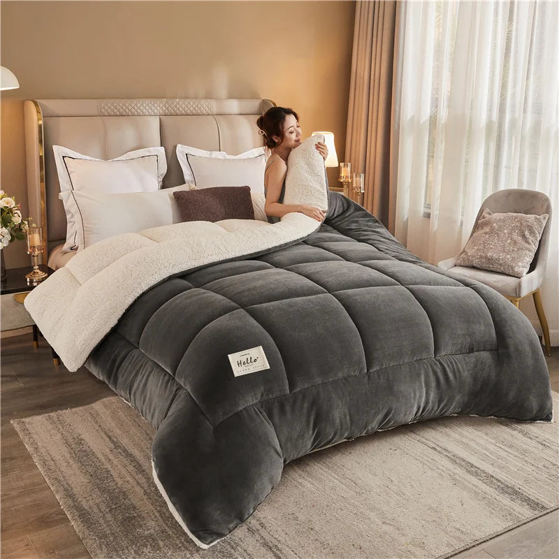 A person is relaxing on a gray weighted fleece blanket in a bedroom setting.