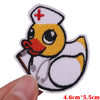 An embroidered patch featuring a yellow duck character wearing a nurse's cap and holding a stick.