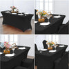 Black stretchable spandex tablecloth covering rectangular dining tables set with plates and floral centerpieces