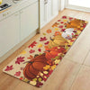 An area rug featuring an autumn design with various orange and yellow pumpkins and maple leaves.