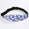 A purple and green patterned baby car seat sleeping headrest with a black adjustable belt strap.