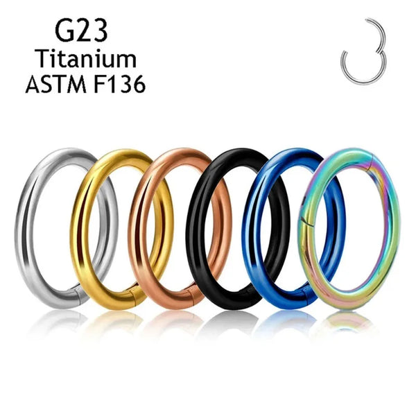 A set of five titanium ASTM F136 hoop rings in various gold and blue finishes.