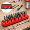 A red magnetic screwdriver bit holder rack with multiple screwdriver bits and a screwdriver tool on a wooden surface.