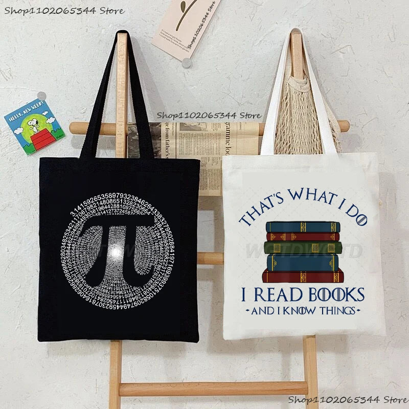Black canvas tote bag featuring an optical illusion design of the Greek letter pi and text that says That's what I do I read 