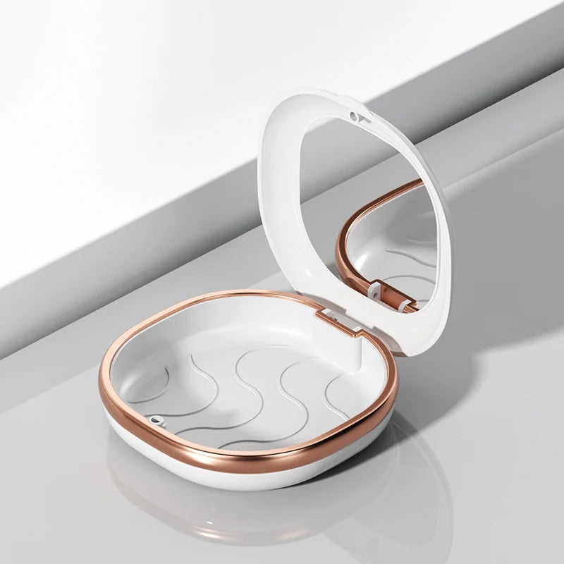 A white compact orthodontic retainer case with a hinged lid and built-in mirror, shown in a studio setting.
