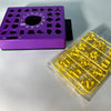 A purple matching puzzle board game with various shapes and a yellow plastic piece set is displayed on a white surface.