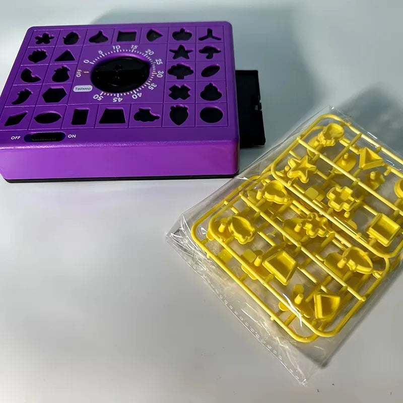A purple matching puzzle board game with various shapes and a yellow plastic piece set is displayed on a white surface.