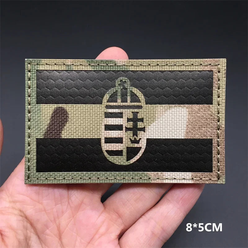 A black and white striped tactical patch featuring a national flag design with hook-and-loop backing.