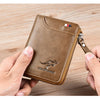 A brown leather wallet with a zipper is being held by a hand on a wooden surface.