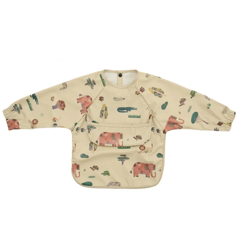A beige waterproof long-sleeve smock for toddlers featuring a colorful pattern of animals and nature elements.