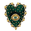 A heart-shaped patch featuring a dark green velvet background, black feathers, and a central gold-colored eye design surround