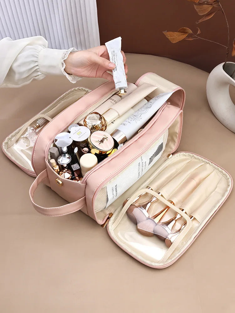 A pink waterproof PU leather cosmetic bag is shown open, filled with various makeup and skincare products, being held by a ha
