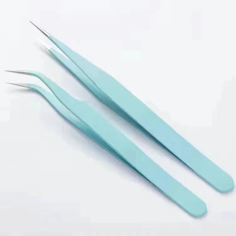 A pair of light blue macaron color craft tweezers for scrapbooking and journaling