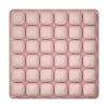 A pink, square foam seat cushion with multiple individual sections for adjustable pressure relief.
