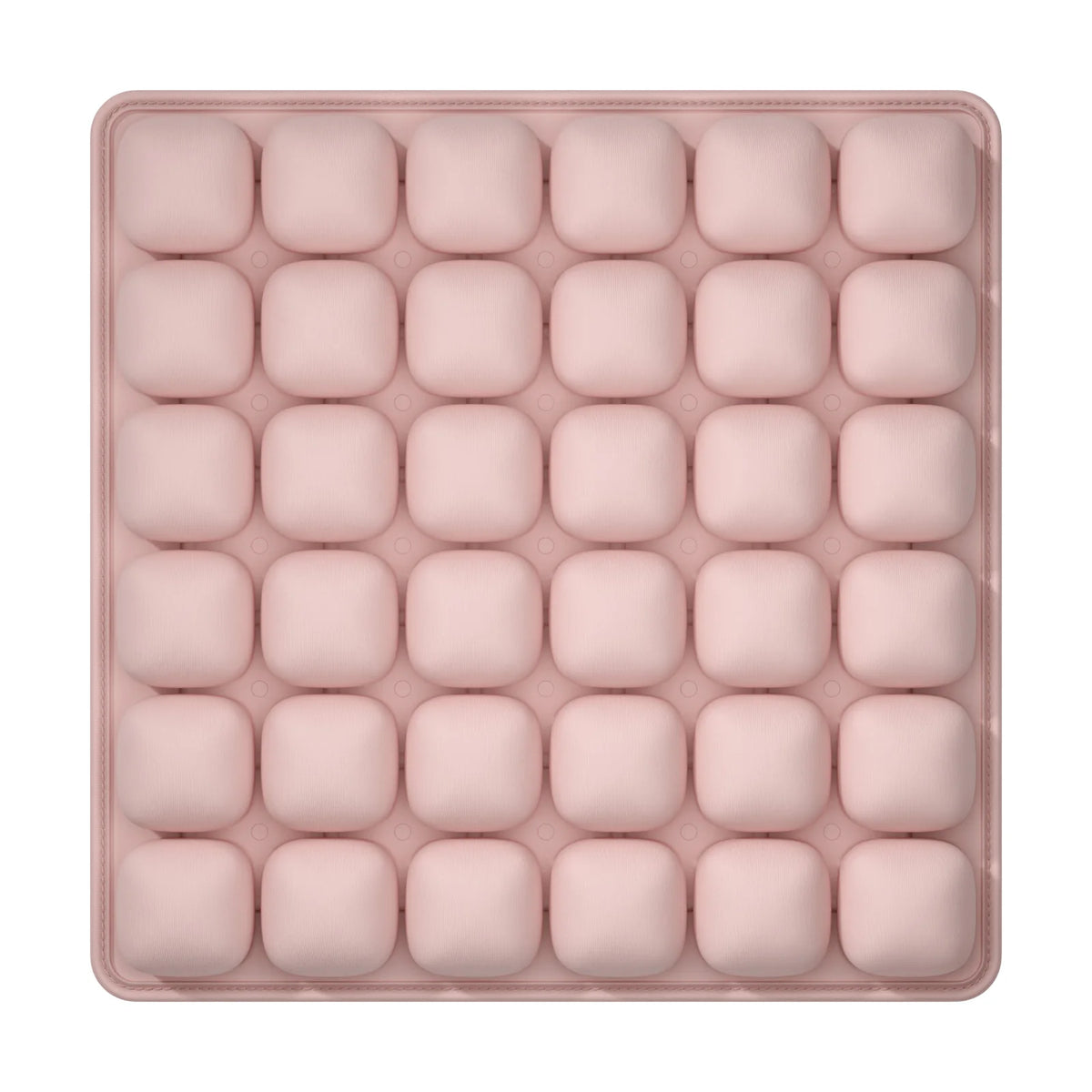 A pink, square foam seat cushion with multiple individual sections for adjustable pressure relief.