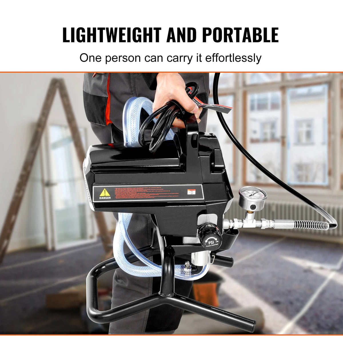 A person is easily carrying a black high-efficiency airless paint sprayer with a hose and pump.
