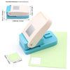 A light blue punch tool is shown next to a sheet of pale green postage stamp paper.