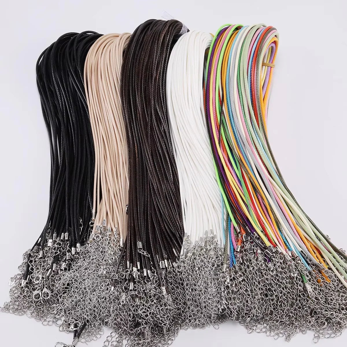 A collection of adjustable leather cord necklaces in various colors including black, beige, brown, and multicolored strands.