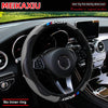 Black carbon fiber steering wheel cover for a car, shown inside the vehicle cockpit.