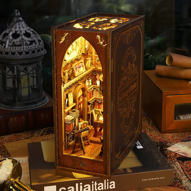 A wooden book nook kit with intricate details and internal LED lighting displayed in a box.
