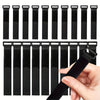 A collection of black reusable nylon cable ties with adjustable hook and loop fasteners shown next to a hand.