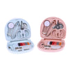 A pink portable mini sewing kit with various needles, scissors, and tools inside the open case.