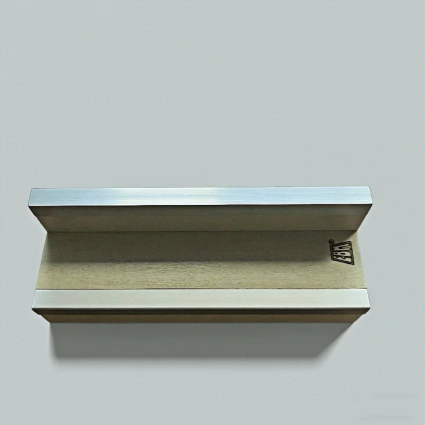 A wooden portable fingerboard ramp set featuring a quarter pipe and rail mounted on a light gray wall.