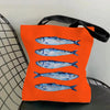 Orange canvas tote bag featuring a print of blue sardines.