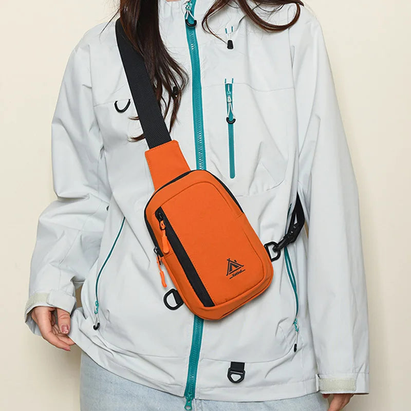 A white jacket features an orange water-resistant nylon chest sling bag attached to the front.