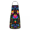 A black apron decorated with colorful Mexican floral art patterns and bird motifs.