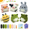 A set of beginner crochet animals including a pig, cow, rabbit, bee, and frogs, along with yarn and needles.