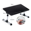 Black adjustable foldable laptop desk with a smooth surface and silver legs.