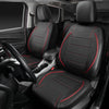 A full set of black leather car seat covers with red stitching installed in a vehicle interior.